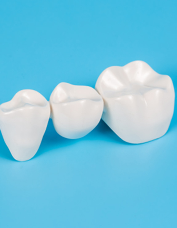 Dental bridge against a light blue background
