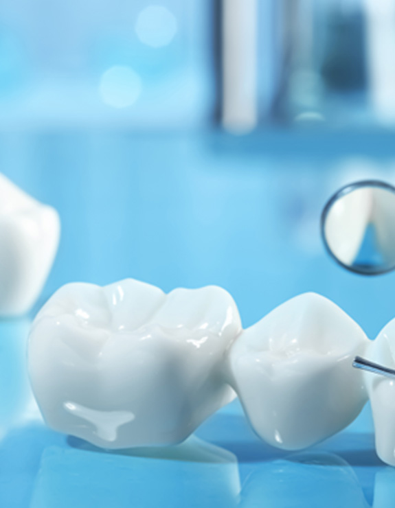 Dental bridge next to a dental mirror