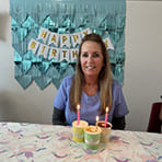 Dental team member with cake with candles of the number 97