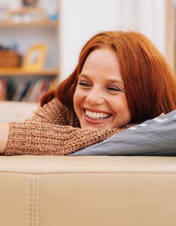 Woman at home relaxing on her couch