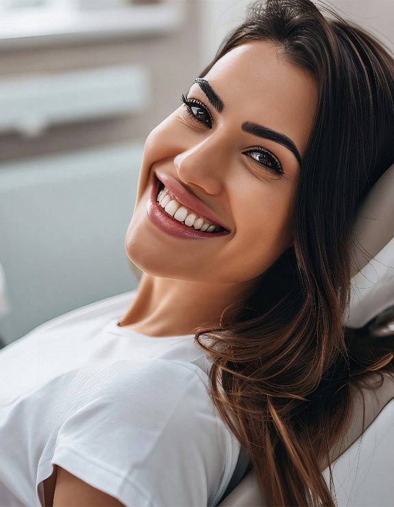 Woman smiling while sitting in treatment chair